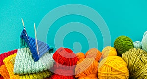 Knitting a rainbow scarf and hat Blue background