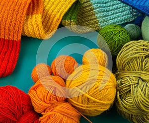 Knitting a rainbow scarf and hat Blue background