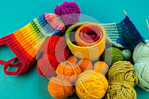 Knitting a rainbow scarf and hat Blue background