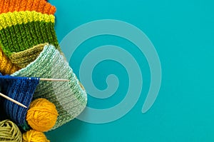 Knitting a rainbow scarf and hat Blue background