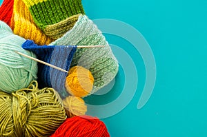 Knitting a rainbow scarf and hat Blue background