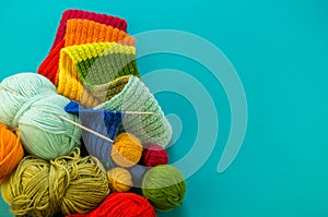 Knitting a rainbow scarf and hat Blue background