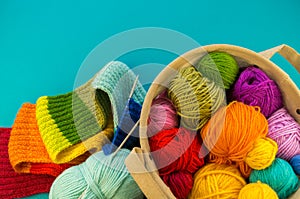 Knitting a rainbow scarf and hat Blue background