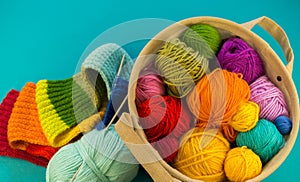 Knitting a rainbow scarf and hat Blue background