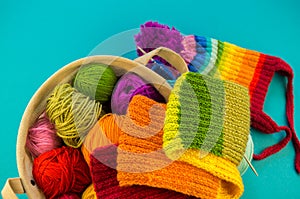 Knitting a rainbow scarf and hat Blue background