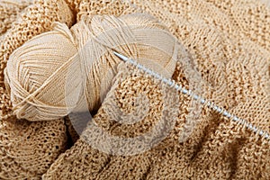 Knitting spokes with ball of wool on tabl