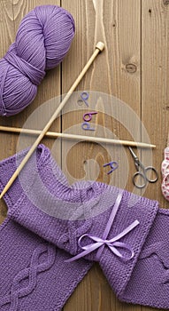 Knitting tools and purple yarn bundle