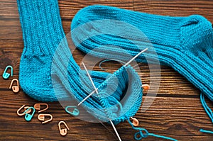 Knitting a warm sock from blue wool yarn