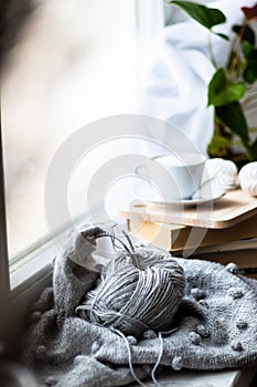 knitting on the window of a cup of coffee book hobby handmade