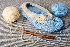 Knitting. wooden crochet hook close-up. Needlework and wool in balls in the background