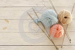 Knitting wool and knitting needles in pastel blue and pink colors