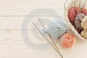 Knitting wool and knitting needles in pastel blue and pink colors