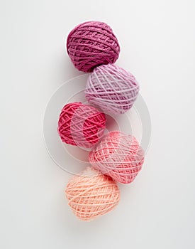 Knitting yarn balls in pink tone.