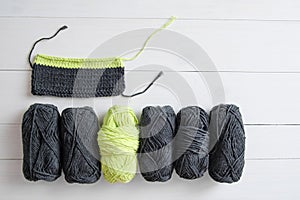 Knitting yarn with knitting pattern on white wooden background. The concept of Hobbies, crafts, the beginning of a new knitting pr