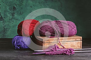 Knitting yarn with needles on grey table