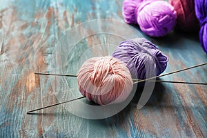 Knitting yarn with needles on wooden table