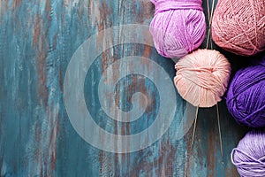 Knitting yarn with needles on wooden table