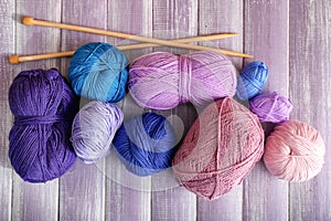 Knitting yarn with needles on wooden table