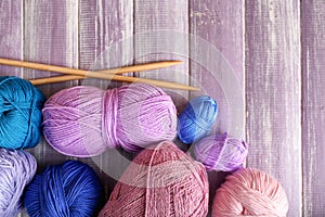 Knitting yarn with needles on wooden table