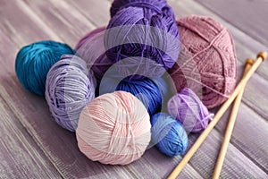 Knitting yarn with needles on wooden table