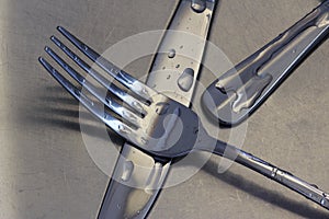 Knives and fork in kitchen sink