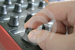 Knob being turned by hand. mixing / mastering