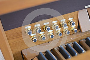 Knobs and pedals of pipe organ in church photo