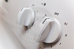 Knobs on a stove close up with shallow depth of field