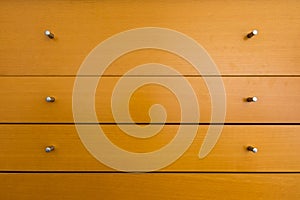 Knobs of Wooden Dresser Drawer Texture Pattern Background