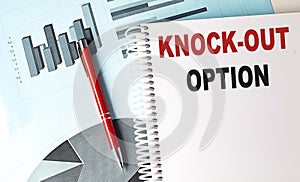 KNOCK-OUT OPTION text on a notebook with pen on a chart background