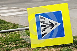 Knocked down european pedestrian crossing sign photo