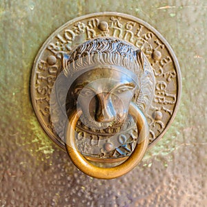 Knocker in the form of a bronze lion's head