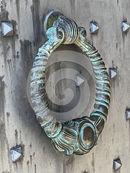 A knocker at the gate to the Benedictine Abbey of Monte Cassino in Italy. Close-up