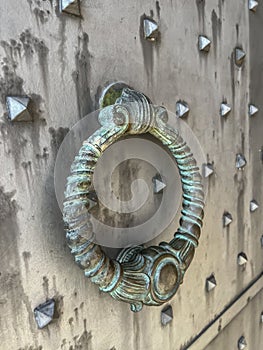 A knocker at the gate to the Benedictine Abbey of Monte Cassino in Italy. Close-up