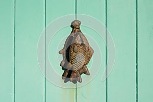 Knocker on light green door