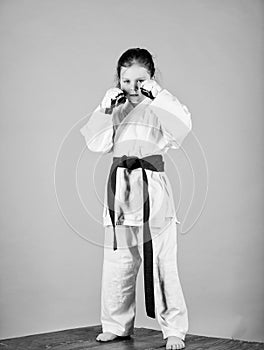Knockout. energy and activity for kids. little girl in gi sportswear. small girl in martial arts uniform. practicing