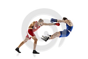 Knockout punch. Two male professional boxers boxing  on white studio background. Concept of sport, competition