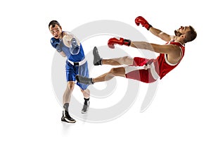 Knockout punch. Two male professional boxers boxing  on white studio background. Concept of sport, competition