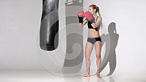 Knockout for the punching bag of the beautiful girl boxer