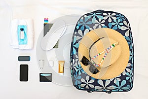 Knolling women travel set with mask, hand sanitiser, straw hat, sunglasses and accessories.