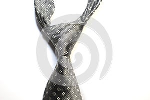Knotted grey tie on a white background