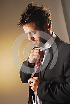 A knotting a tie