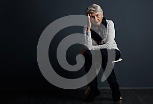 We know all about frustration at our age. Studio shot of a stressed out elderly woman sitting down and contemplating