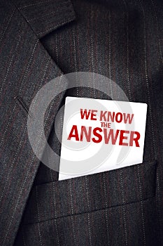 We Know The Answer business card in suit pocket