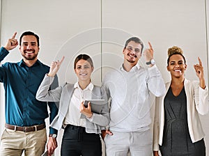 We know just how to keep your business growing. Portrait of a group of businesspeople standing in an office.