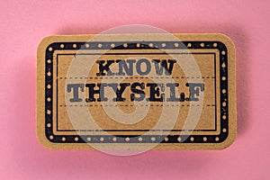 Know Thyself. Cardboard sticker with text on a pink background