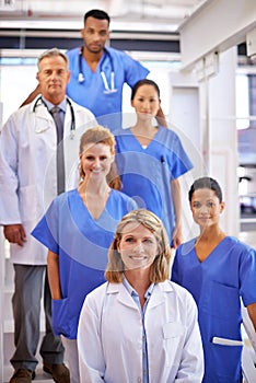 They know what theyre doing. Portrait of a diverse team of medical professionals standing on a staircase in a hospital.