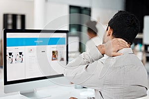 Know when you need a break. a young call centre agent experiencing neck pain while working in an office.