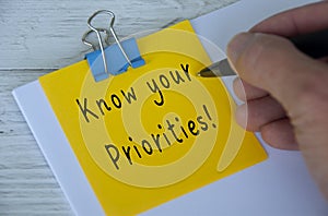 Know your priorities text written on yellow notepad. Priority concept