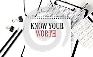 KNOW YOUR WORTH word on notepad with clipboard , chart and calculator, business concept